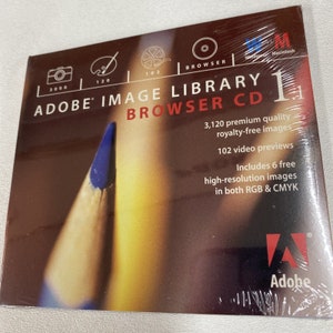 May include: A CD case for Adobe Image Library Browser 1.1, featuring a blue pencil on a yellow background. The case includes 3,120 royalty-free images, 102 video previews, and 6 free high-resolution images in both RGB and CMYK.