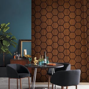 May include: A dining room with a dark blue wall and a wall covered in a wood paneling with a hexagonal pattern. A black table with four black chairs sits in front of the wood paneling wall. There are two wine bottles, a glass, and a small plant on the table.
