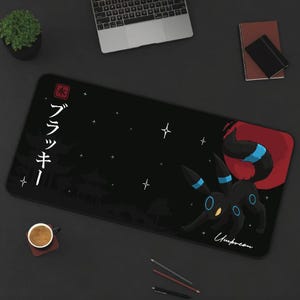 May include: Black and red gaming mouse pad with a black and blue cartoon of a Pokemon character, Umbreon, with the Japanese text "ブラックキー" in white.