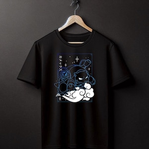 May include: Black t-shirt featuring a blue and white graphic of a cartoon character in a cloud with stars and Japanese text.