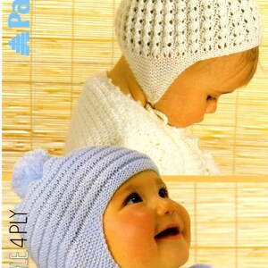 May include: Two baby bonnets are shown in the image. The top bonnet is white with a pom-pom and a textured knit pattern. The bottom bonnet is light blue with a pom-pom and a knitted design. The text "FAIRYTALE 4 PLY" is visible.
