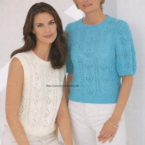 Puede incluir: Dos mujeres con tops de punto. Una lleva un top sin mangas color crema, y la otra un top azul claro de manga corta. Ambos tops tienen un patrón calado detallado. Llevan pantalones blancos.