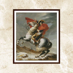 Pode incluir: Impressão emoldurada de uma pintura histórica que retrata um homem em um cavalo branco empinado. O homem, usando um chapéu bicorne e uma capa vermelha, aponta para a frente. O fundo mostra uma paisagem nevada e um céu nublado.