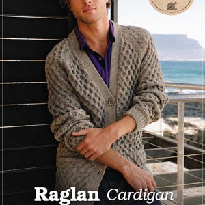 May include: A beige raglan cardigan with a textured honeycomb knit pattern, a V-neckline, and a single button closure. The garment is worn over a purple collared shirt. Text on the image includes Pattern Raglan Cardigan, A CHALLENGING BUT FUN KNIT, KNITTING PATTERN SIZES S-M-L-XL, and Etsy Shop SonyaCrossStitch.