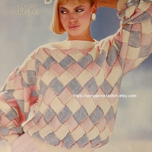 May include: A woven-pattern sweater in pastel pink, blue, and cream colors. The sweater has a crew neck and long sleeves. The image also includes the text "Wendy D.K." and the number "3051".