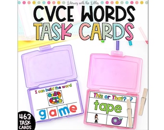 May include: Two open plastic cases containing CVCE word task cards. One case is purple, the other pink. The cards feature colourful illustrations and the words "game" and "tape". The text "CVCE WORDS TASK CARDS" is at the top of the image.