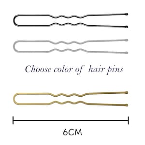 May include: Three hair pins in black, silver, and gold. Each pin is 6 inches long and has a wavy design. Choose your favorite color.