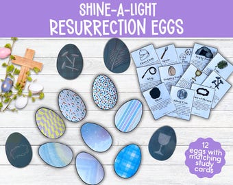 May include: Twelve decorated Easter eggs with matching study cards. The cards feature text and illustrations related to the story of Jesus's crucifixion and resurrection. The eggs are decorated with various patterns and colors, including blue, white, and gray.