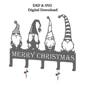 May include: A gray metal wall-mounted key holder featuring four gnome figures above the words "MERRY CHRISTMAS." Each gnome has a different hat design. The key holder has four hooks with decorative keychains.