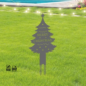 May include: A grey metal Christmas tree silhouette with the words "Merry Christmas" inscribed on it. The tree is standing in a grassy lawn with a string of white lights strung above.