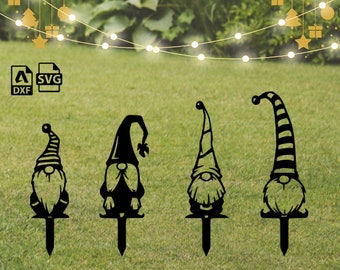 May include: Four black metal silhouette gnomes with different hat designs. The gnomes are standing on stakes, ready to be placed in the ground.