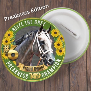 May include: A round button with a horse illustration, the text "SEIZE THE GREY", and "Preakness Edition". The button features a horse head, sunflowers, and the words "Proud Owner", "Preakness 149 Champion", and the number 6.