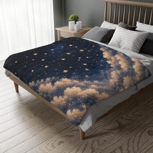 May include: A dark blue blanket with a celestial design featuring golden stars and cloud-like formations. The blanket is draped over a wooden bed frame, creating a cozy and inviting atmosphere. The blanket's dimensions are not visible.