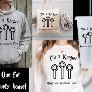 May include: Four different items featuring a Harry Potter Quidditch Keeper design. A gray hoodie, a white tote bag, a white t-shirt, and a clear plastic tumbler. Each item has the text "I'm a Keeper" and a graphic of three Quidditch Keeper snitch catching hoops. Each item also has the name of a different Hogwarts house: Slytherin, Hufflepuff, Gryffindor, and Ravenclaw.
