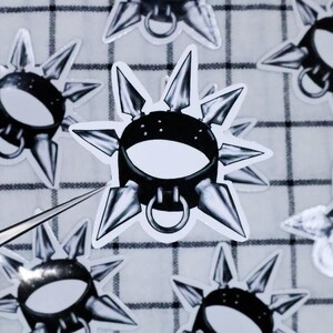 May include: A black leather collar with silver spikes and a silver ring. The collar is on a white background.