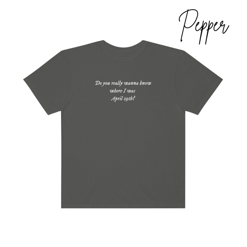 May include: A dark gray t-shirt with the text "Do you really wanna know where I was April 29th?" printed on the back.