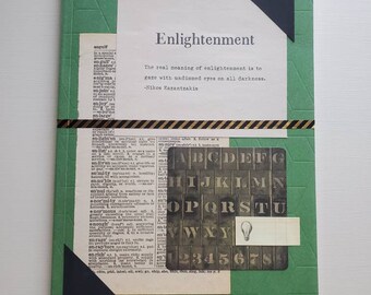 May include: A green journal with a black triangle corner bookmark. The cover has a geometric pattern and a quote about enlightenment by Nikos Kazantzakis. The quote reads: "The real meaning of enlightenment is to gaze with undimmed eyes on all darkness."