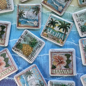 May include: Square ceramic tiles with Hawaiian-themed designs. The tiles feature images of palm trees, waves, pineapples, and hibiscus flowers, with text such as "Aloha" and "Hawaii". The tiles are arranged on a blue and white patterned surface.