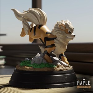 May include: A tan and black canine figurine with a large cream-colored mane and tail, posed in a dynamic running stance on a rocky, green-grassed base. The base is mounted on a black circular stand with the text MAPLE 3D PRINTING visible.