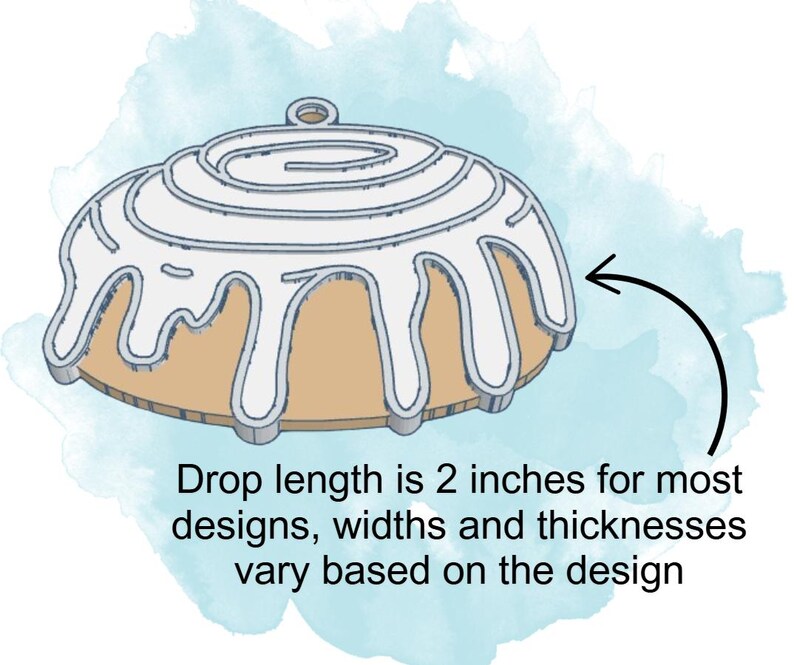 May include: A white icing cinnamon roll ornament with a 2-inch drop length. The ornament is made of wood and is perfect for decorating a Christmas tree or adding a festive touch to any room.