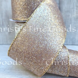 May include: A roll of brown and gold glitter ribbon with a gold wired edge. The ribbon has a subtle shimmer and is perfect for adding a touch of sparkle to any craft project.