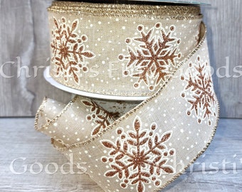 Beautiful Rose Gold Glitter Snowflakes on a Tan Base Gold Edges and White Accents Wired Ribbon 2.5" inches Wide Comes in 5 Yard Increments.