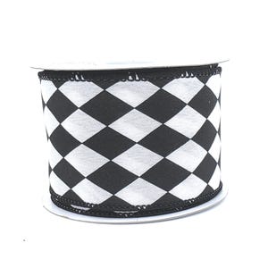 May include: A roll of decorative ribbon featuring a black and white harlequin pattern. The ribbon is tightly wound on a cardboard spool, ready for use in crafts, gift wrapping, or other decorative projects. The pattern consists of alternating black and white diamond shapes.