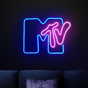 May include: A neon sign with the MTV logo. The "M" is blue and the "TV" is pink.