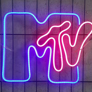 May include: A neon sign with the MTV logo in blue and pink. The sign is made of thin tubing and is lit up.