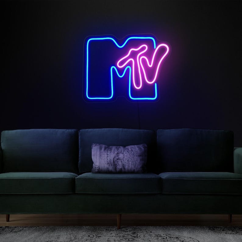May include: A neon sign with the MTV logo. The "M" is blue and the "TV" is pink.