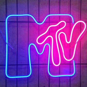 May include: A neon sign with the letters "MTV" in a blue outline and a pink interior. The "M" is shaped like a hand with the thumb pointing up.
