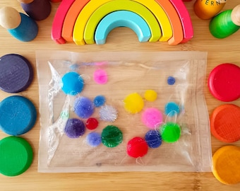 Bolsa sensorial líquida Pompones de colores Actividad sensorial Montessori para bebés y niños.