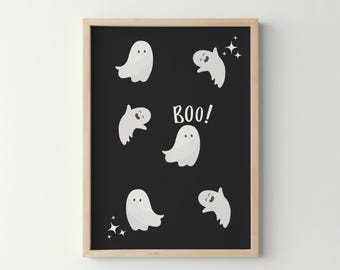 May include: A framed wall art print featuring a black background with six white cartoon ghosts in various poses and the white text BOO! centered in the middle. The design includes small white four-pointed star accents scattered around the ghosts.