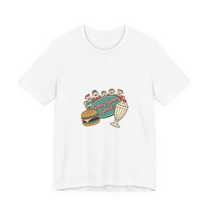 May include: White t-shirt featuring a retro diner graphic. The graphic includes a burger, milkshake, and the text "Greasy Spoon Special!" above a group of cartoon characters. The design has a vintage, diner-style aesthetic.