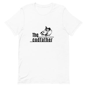May include: White t-shirt with a black graphic of a fish and the text "The codfather" printed on the front.