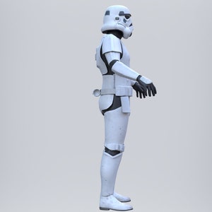 May include: A white stormtrooper action figure with black details. The figure is standing with its arms at its sides.