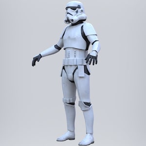 May include: A white stormtrooper action figure with black details. The figure is standing with its arms outstretched.