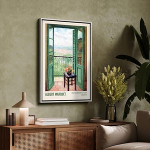 May include: A vintage poster featuring a painting of an open balcony door with a view of a cityscape. The door is green and the balcony is iron. A small table with a vase of flowers sits on the balcony. The poster is titled "ALBERT MARQUET" and includes the text "WINDOW LOOKING OUT ON THE BAY OF ALGIERS, PAINTED IN 1912."