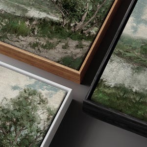 May include: Three framed landscape paintings with different colored frames. The frames are wood and black. The paintings are all oil paintings with a textured surface.