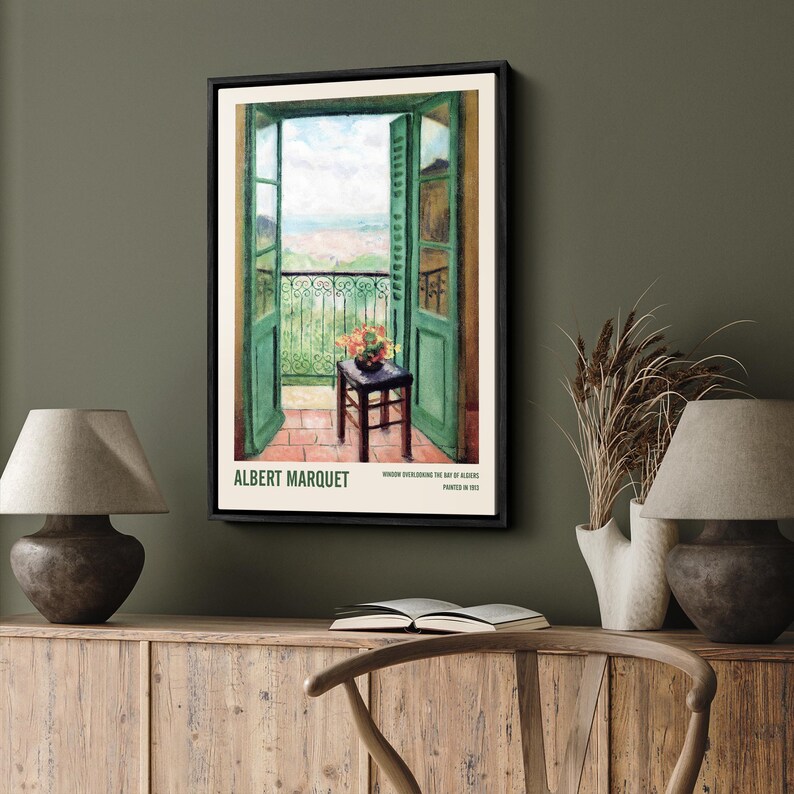May include: A framed painting of a green door opening to a balcony overlooking a cityscape. The painting is by Albert Marquet and is titled "Window overlooking the Bay of Algiers, painted in 1913."