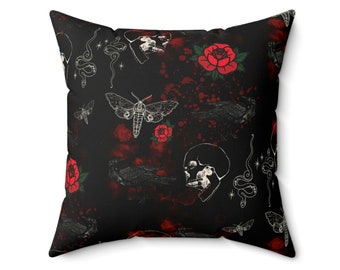May include: Black and red throw pillow with a gothic pattern featuring skulls, roses, moths, and snakes. The pattern is repeated on a black background.