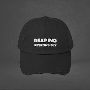 May include: Black distressed baseball cap with white embroidered text that reads "REAPING RESPONSIBLY".