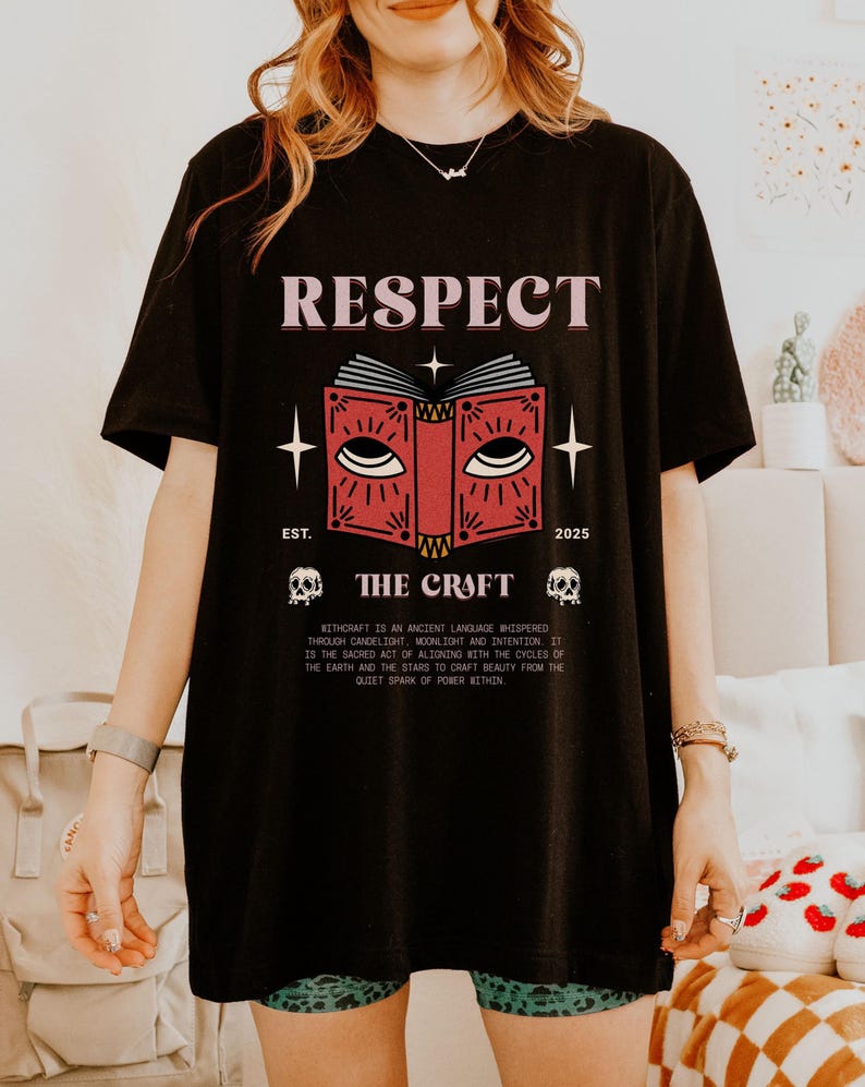 May include: Black t-shirt with the word "RESPECT" above a red book graphic with eyes. The text "THE CRAFT" is below the book, with "EST. 2025" and two skull graphics. The shirt also has a paragraph of text.