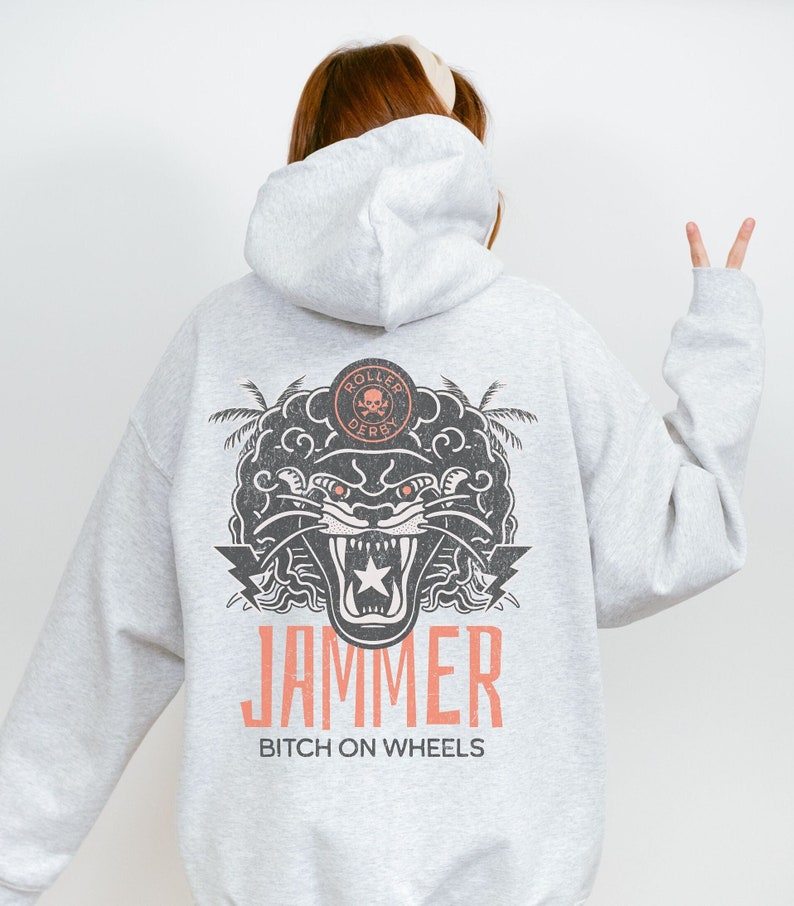 May include: Grey hooded sweatshirt with a black and white graphic of a snarling panther with a star on its forehead. The graphic also includes palm trees and the text "Roller Derby" and "JAMMER BITCH ON WHEELS".