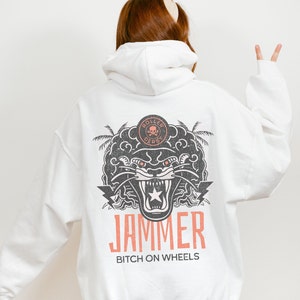 May include: White hooded sweatshirt with a black and white graphic of a panther with the text "ROLLER DERBY" and "JAMMER BITCH ON WHEELS" printed on the back.