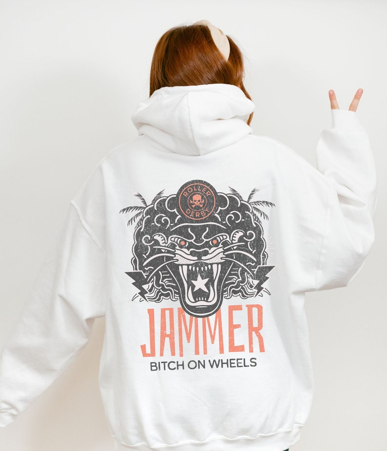 May include: White hooded sweatshirt with a black and white graphic of a panther with the text "ROLLER DERBY" and "JAMMER BITCH ON WHEELS" printed on the back.