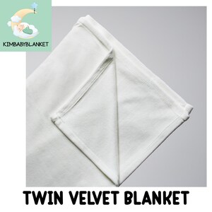 A white twin velvet blanket is shown against a light gray background.