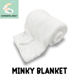 A white, fluffy, and soft-looking blanket is shown in the image.
