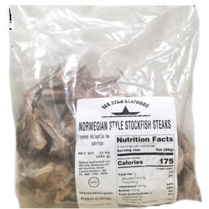 May include: A clear plastic bag filled with Norwegian Style Stockfish Steaks. The bag has a white label with the text "Sea Star Seafoods" and "Nutrition Facts". The net weight is 12 oz (340 g).