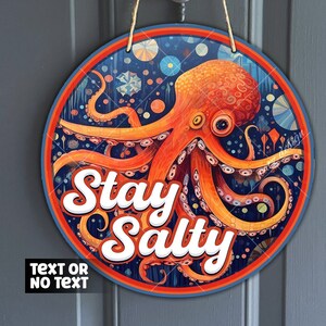May include: A round wooden sign with a blue background and a colorful octopus with the text "Stay Salty" in white letters.